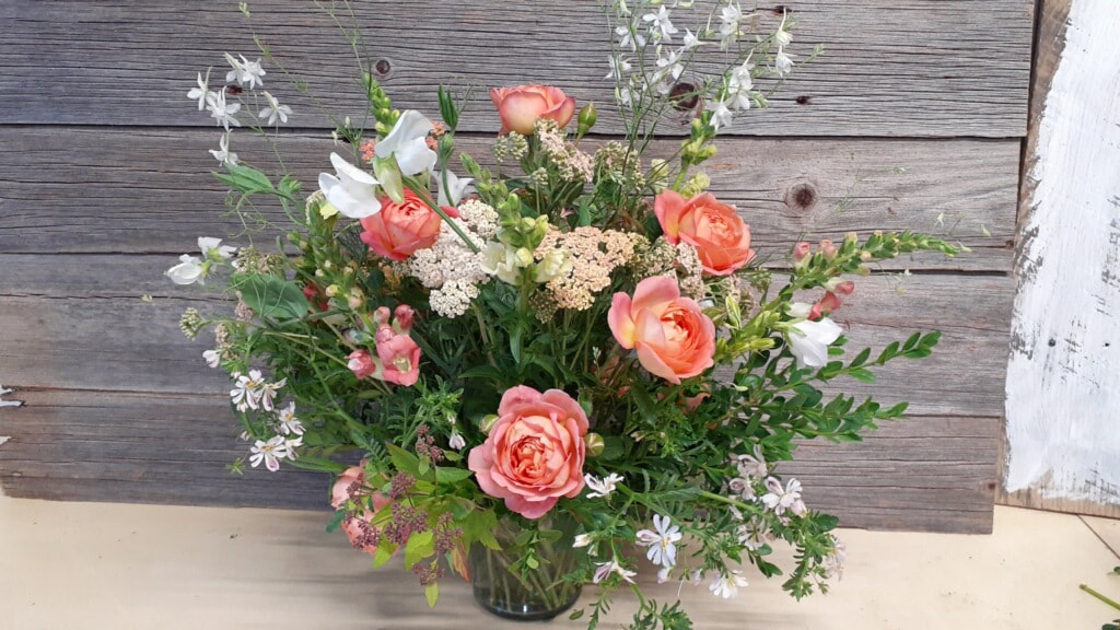 corral garden rose bouquet with mixed foliage
